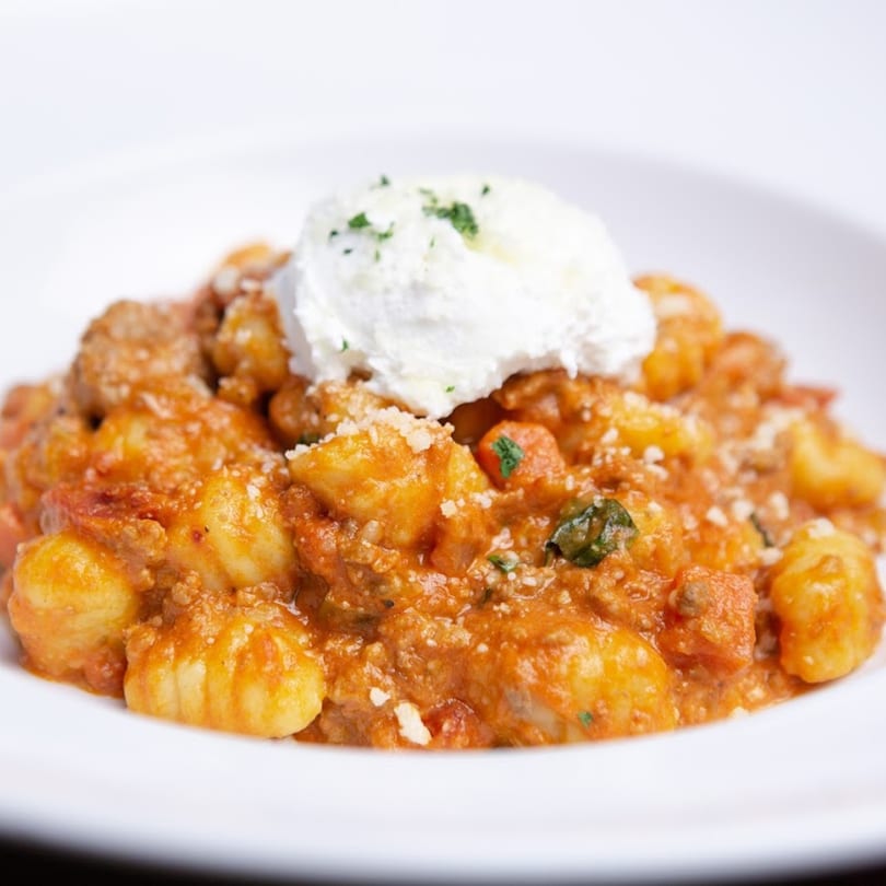 Lido's gnocchi with a rich red sauce, sausage, parmesan, and a dollop of ricotta cheese.